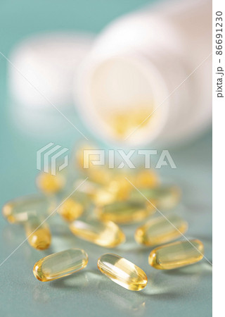 soft gelatin capsules with fish oil in a white bottle, close-up 86691230