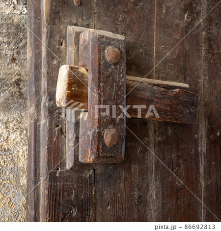 Closeup of a wooden aged latch 86692813