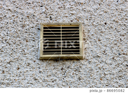 Ventilation Duct Cover on a Roughcast House Rear Wall 86695082
