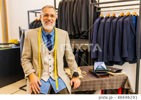 mature tailor working with sewing pattern in atelier mature tailor working with sewing pattern in atelier 86696291