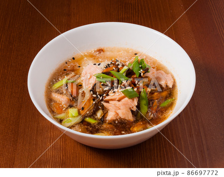 Shanghai soup with mussels and fish in a white bowl Shanghai soup with mussels and fish in a white bowl 86697772