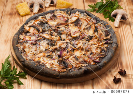 pizza with chicken and mushrooms and teriyaki sauce on black dough pizza with chicken and mushrooms and teriyaki sauce on black dough 86697873