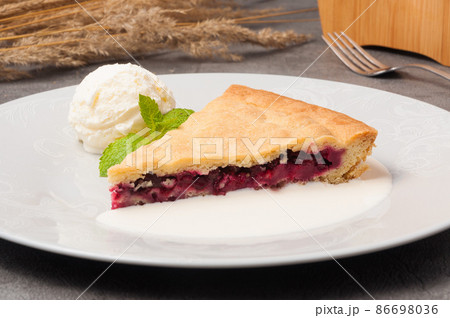 cherry shortbread pie with ice cream, garnished with mint 86698036