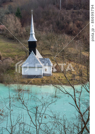 Toxic waste waters from a copper and gold mine submerge village. Abandoned orthodox church on lakeside Toxic waste waters from a copper and gold mine submerge village. Abandoned orthodox church on lakeside 86699794