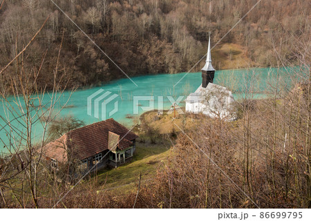 Toxic waste waters from a copper and gold mine submerge village. Abandoned orthodox church on lakeside Toxic waste waters from a copper and gold mine submerge village. Abandoned orthodox church on lakeside 86699795