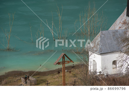Toxic waste waters from a copper and gold mine submerge village. Abandoned orthodox church on lakeside Toxic waste waters from a copper and gold mine submerge village. Abandoned orthodox church on lakeside 86699796