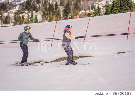Woman learning to ski with instructor. Winter sport. Ski lesson in alpine school 86700188