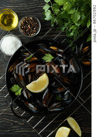 Concept of delicious food with mussels on wooden table 86702992