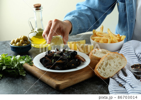Concept of delicious food with mussels on black smokey table 86703014