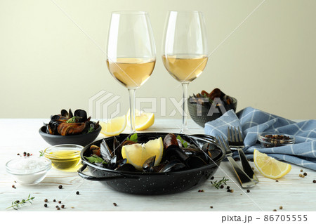 Concept of delicious food with mussels on white wooden table 86705555