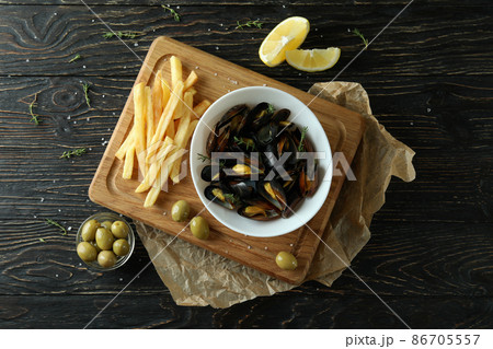 Concept of delicious food with mussels on wooden table 86705557