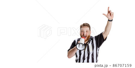 Flyer with young emotional bearded man, soccer or football referee shouting at megaphone isolated on white studio background. Concept of sport, rules, competitions, rights, ad, sales. 86707159