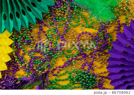 Mardi gras carnivale green, purple, yellow beads and colorful decorations Mardi gras carnivale green, purple, yellow beads and colorful decorations 86708062
