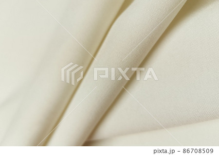 White crumpled or wavy fabric texture background. Abstract linen cloth soft waves. Gabardine wool fabric. Merino yarn. Smooth elegant luxury cloth texture. Concept for banner or advertisement. White crumpled or wavy fabric texture background. Abstract linen cloth soft waves. Gabardine wool fabric. Merino yarn. Smooth elegant luxury cloth texture. Concept for banner or advertisement. 86708509