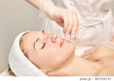 Doctor doing skin routine. Salon maternity treatment. Health care concept Doctor doing skin routine. Salon maternity treatment. Health care concept 86709145