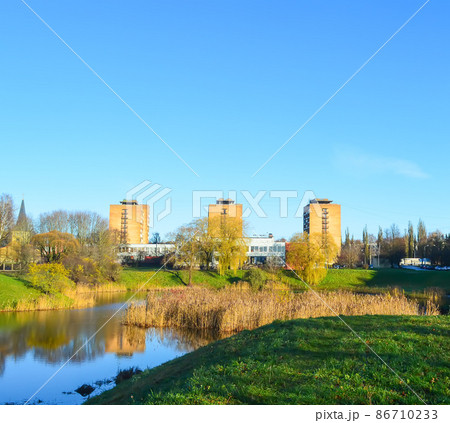 Urban landscape with modern buildings and pond. Urban landscape with modern buildings and pond. 86710233