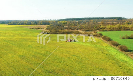 4K Aerial Elevated View Of Combine Harvester And Tractor Working Together In Field. Harvesting Of Oilseed In Spring Season. Agricultural Machines Collecting Rapeseeds Canola Colza Rural Landscape 4K Aerial Elevated View Of Combine Harvester And Tractor Working Together In Field. Harvesting Of Oilseed In Spring Season. Agricultural Machines Collecting Rapeseeds Canola Colza Rural Landscape 86710349