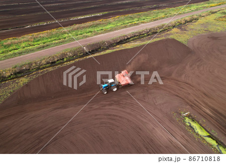 Peat Harvester Tractor on Collecting Extracting Peat. Peat Harvester Tractor on Collecting Extracting Peat. 86710818