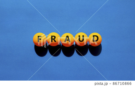 Fraud symbol. Orange table tennis balls with the words 'fraud'. Beautiful blue background, copy space. Warm sunshine. Business, fraud concept. Fraud symbol. Orange table tennis balls with the words 'fraud'. Beautiful blue background, copy space. Warm sunshine. Business, fraud concept. 86710866