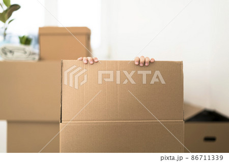 Cute toddler boy playing in cardboard box at new home. 86711339