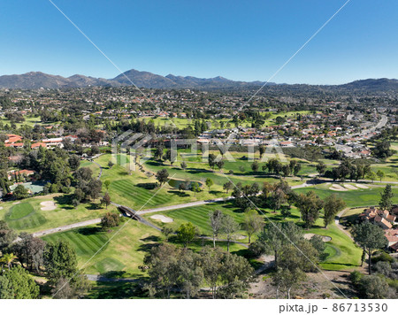 Aerial view of green golf in upscale residential neighborhood in South California 86713530