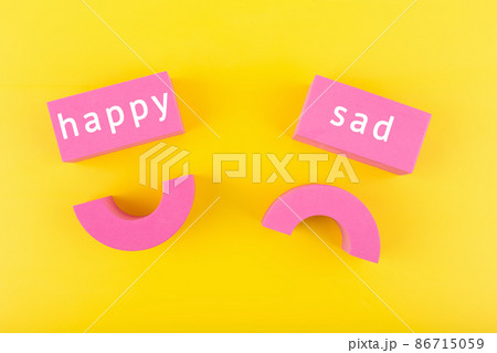 Unhappy and happy smile symbols next to each other on yellow background. Concept of World Smile day, emoji or customer satisfaction evaluation Unhappy and happy smile symbols next to each other on yellow background. Concept of World Smile day, emoji or customer satisfaction evaluation 86715059