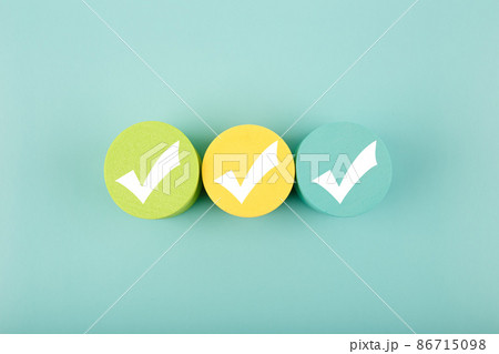 Three white checkmarks on colorful circles against bright aqua blue background Three white checkmarks on colorful circles against bright aqua blue background 86715098