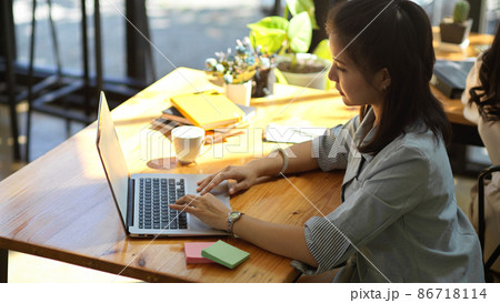 A professional female manager working, typing on portable laptop A professional female manager working, typing on portable laptop 86718114
