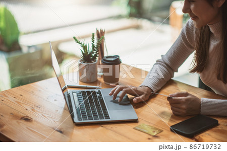 Young asian smiling woman resting and shopping online at home, Happy woman using laptop and credit card for online shopping 86719732