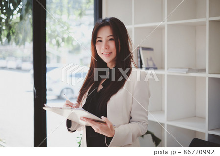 Asian Business woman working to analyze technical price graph and indicator. account or saving money or insurance concept. 86720992