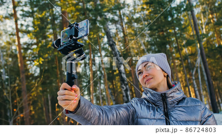 Woman Holding On Handheld Film 3-axis Gimbal Stabilization Devic Woman Holding On Handheld Film 3-axis Gimbal Stabilization Devic 86724803