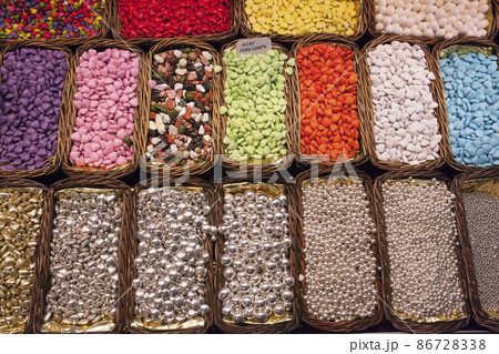 sweets, jelly beans of different colors, in baskets on the shelves sweets, jelly beans of different colors, in baskets on the shelves 86728338