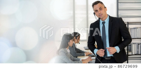 Business people wearing headset working in office broaden view Business people wearing headset working in office broaden view 86729699
