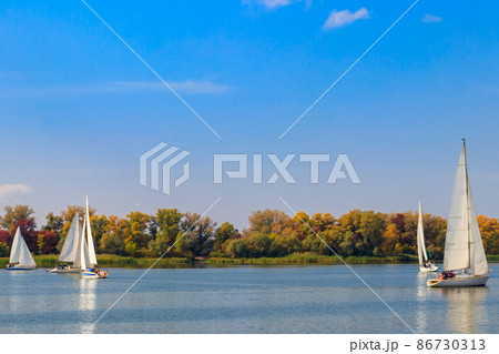 Yachts at sailing regatta on the Dnieper river in Kremenchug, Ukraine Yachts at sailing regatta on the Dnieper river in Kremenchug, Ukraine 86730313