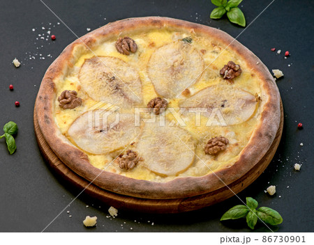 Fruit homemade sweet pear pizza with cheese and nuts, Rustic Italian savory food with pastry dough, top view, copy space Fruit homemade sweet pear pizza with cheese and nuts, Rustic Italian savory food with pastry dough, top view, copy space 86730901