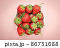 Top view of fresh strawberry in a bowl on isolated pink background. 86731688