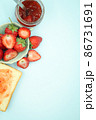 Top view of toast strawberries and jam on isolated pastel background with copy space. 86731691