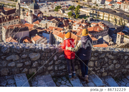Mom and son travelers in Montenegro in Kotor Old Town Ladder of Kotor Fortress Hiking Trail. Aerial drone view 86732229