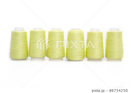 Yellow spool of thread isolated on white background. Skein of woolen threads. Yarn for knitting. Materials for sewing machine. Coil. 86734250