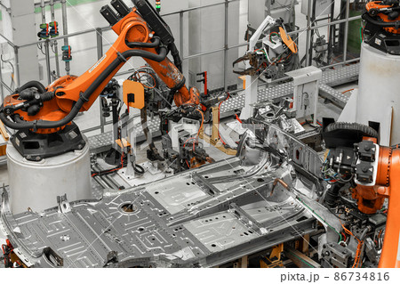 Photo of automobile production line. Welding car body. Modern car assembly plant. Auto industry Photo of automobile production line. Welding car body. Modern car assembly plant. Auto industry 86734816