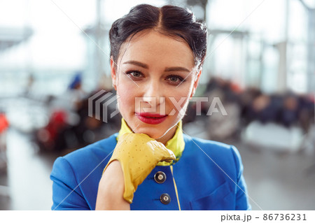 Female airline worker standing in airport terminal 86736231