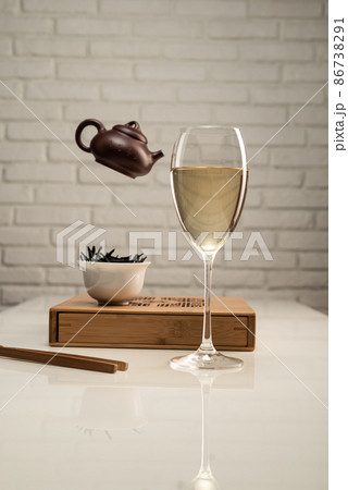 tea table with appliances and a wine glass in which tea is brewed 86738291