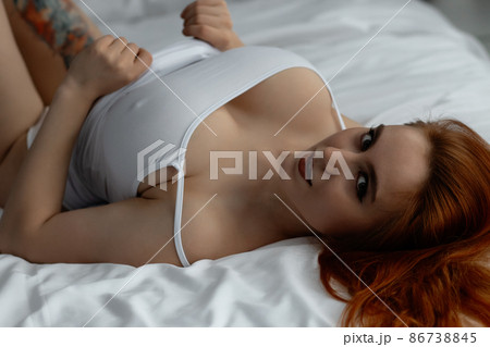 Sensual ginger woman in underwear on bed 86738845