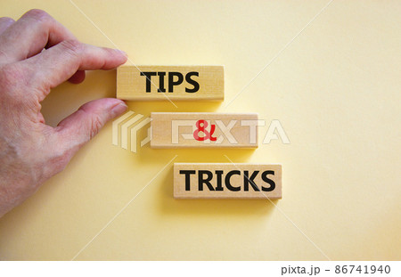 Tips and tricks symbol. Concept words Tips and tricks on wooden blocks. Beautiful white table white background. Businessman hand. Business, tips and tricks concept. Copy space. Tips and tricks symbol. Concept words Tips and tricks on wooden blocks. Beautiful white table white background. Businessman hand. Business, tips and tricks concept. Copy space. 86741940