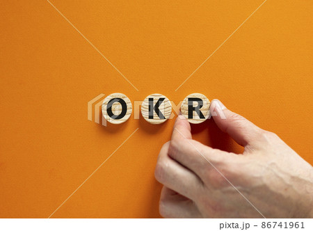 OKR, objectives and key results symbol. Concept words OKR objectives and key results on wooden circles on a beautiful orange background. Business OKR objectives and key results concept. Copy space. 86741961