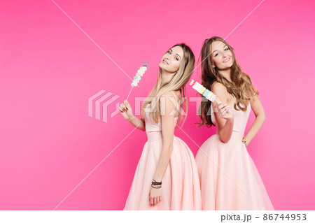 Two sweet girls like dolls posing at pink studio 86744953