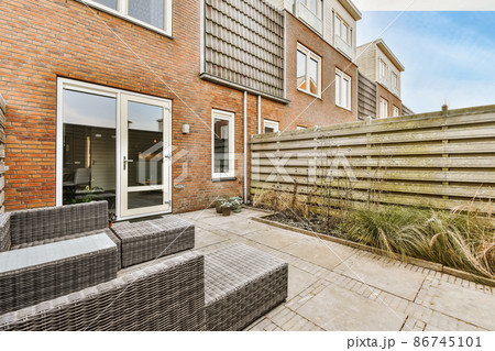 Magnificent design of the courtyard of the house with wicker furniture 86745101