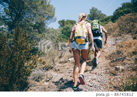 Couple of hikers walking up path together Couple of hikers walking up path together 86745812