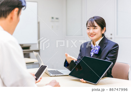 タブレットを使って説明をする女性（スマホ） 86747996