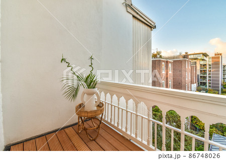 balcony with a houseplant,wooden floor and street view balcony with a houseplant,wooden floor and street view 86748026